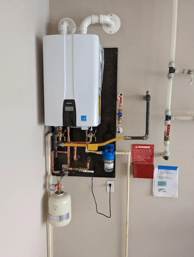 Professional plumber installing copper piping in a Delhi home